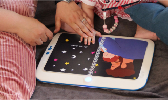 Photographie représentant un enfant d’environ 1 an et un parent en train d’utiliser un prototype de la console